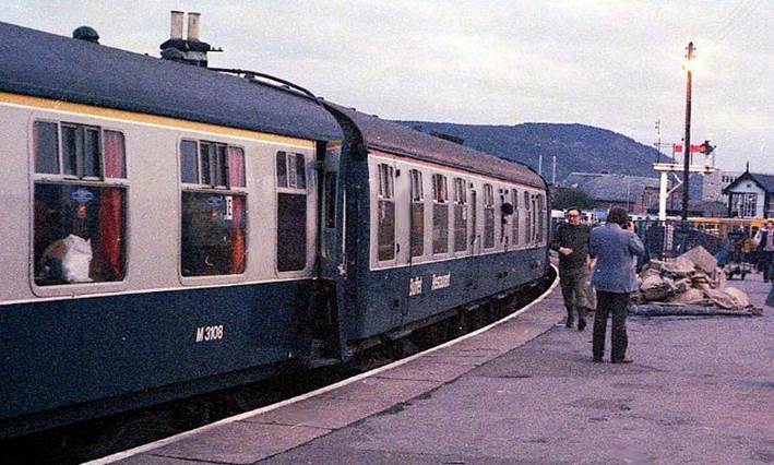 UIC yellow First-class and red catering cantrail bands on adjacent coaches in the 'Far-North' line platform at Inverness on 11th September 1982.
Ready to depart north to Wick & Thurso, the train was a Friday to Sunday railtour from London. First Open no.M3108 is coupled to a Mk1 restaurant /kitchen car. 
